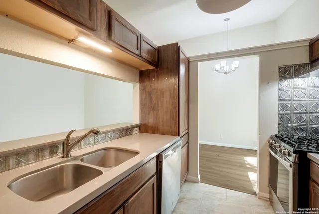 a kitchen with a stove and a refrigerator