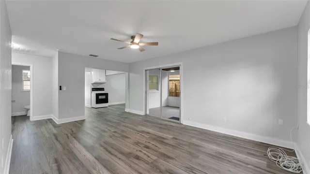 a view of an empty room with wooden floor