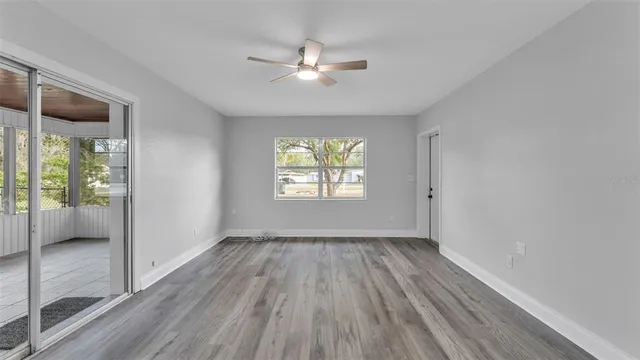 wooden floor in an empty room with a window