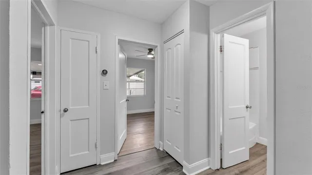 a view of a bathroom with wooden floor and mirror