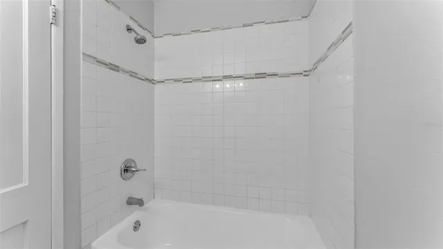 a bathroom with a shower and a bath tub