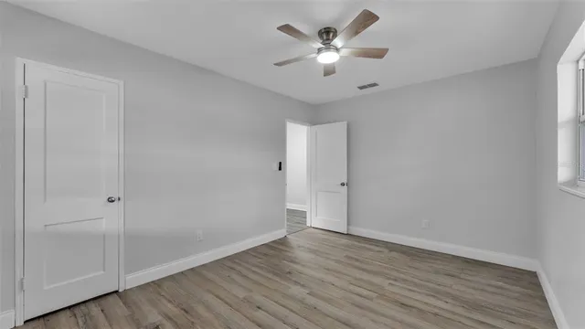 a view of an empty room with wooden floor