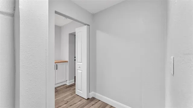 a view of a hallway with wooden floor