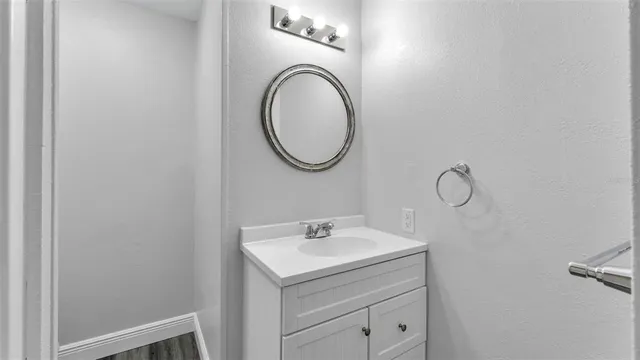 a white toilet sitting next to a shower