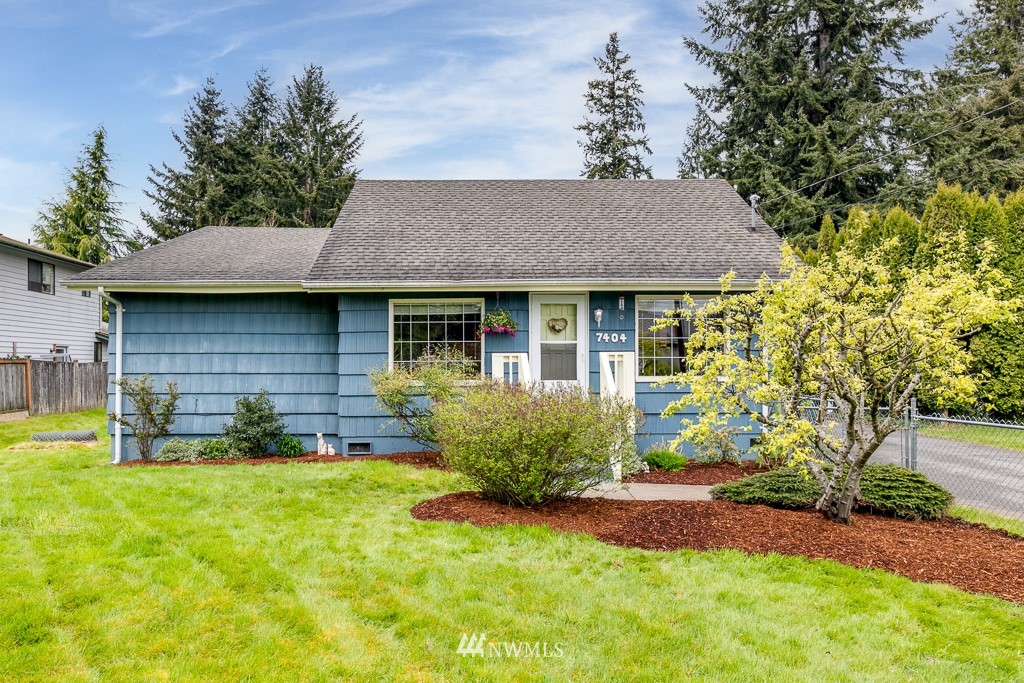 7404 Lower Ridge Road Everett, WA 98203 - Photo 1 of 33 a front view of a house with a garden and yard