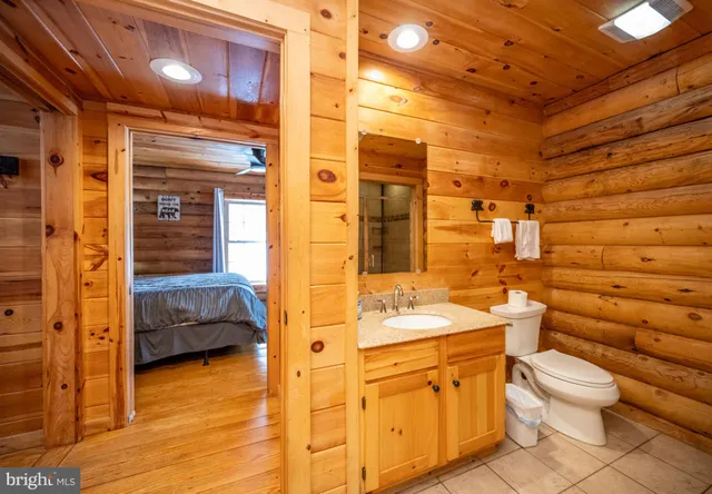 a spacious bathroom with a double vanity sink a mirror and a shower