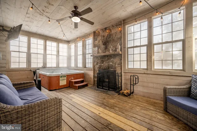 a room with a fireplace and windows