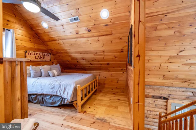 a bedroom with furniture and wooden floor