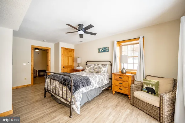 a bedroom with furniture and a window