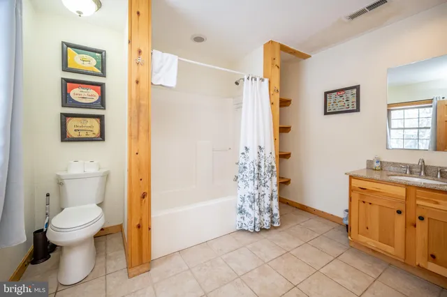 a bathroom with a toilet tub and shower