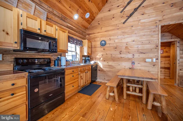 a kitchen with stainless steel appliances granite countertop a stove a refrigerator and a microwave oven with cabinets