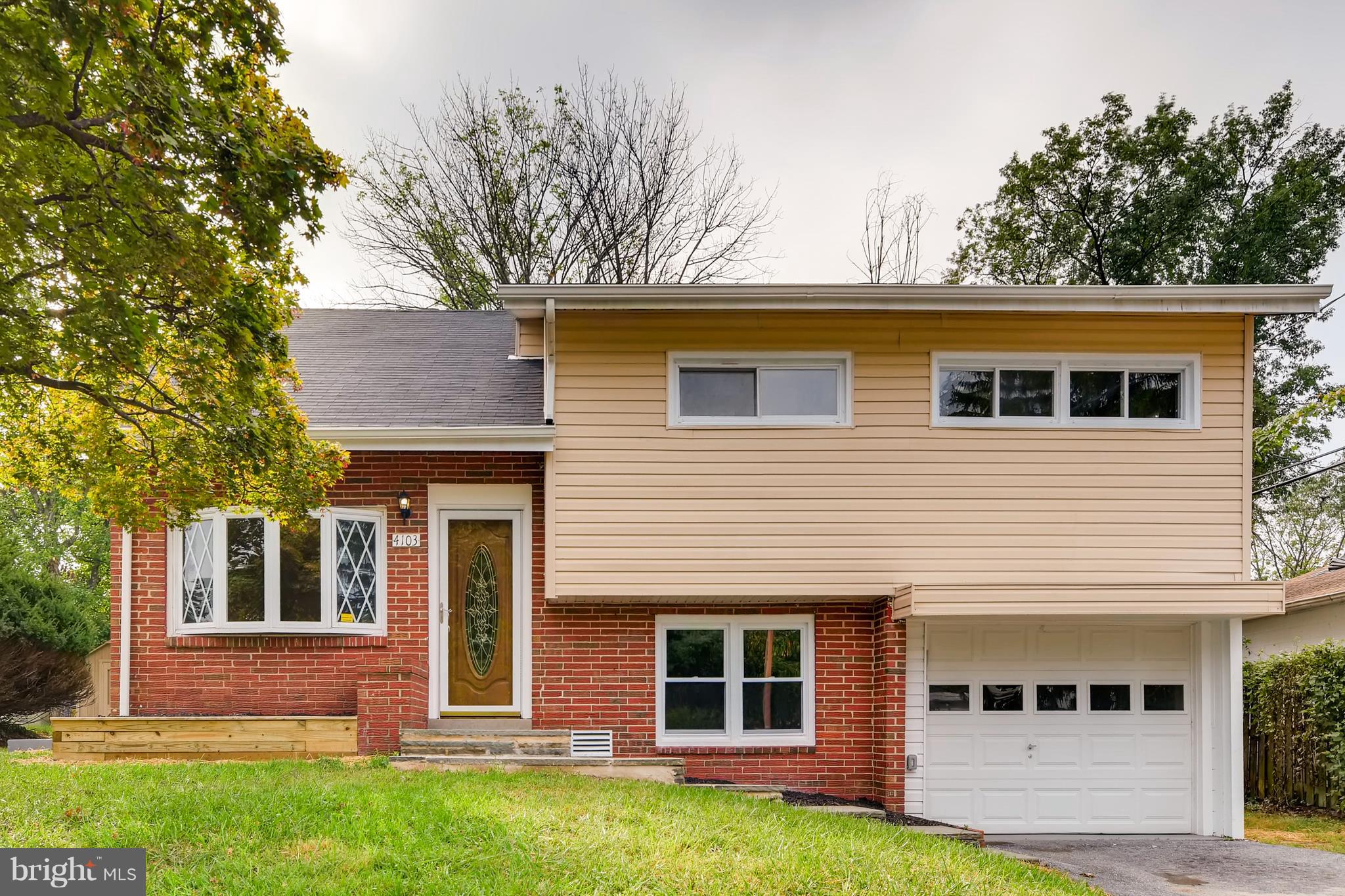 4103 Ronis Road Baltimore, MD 21208 - Photo 2 of 22 a front view of a house with a yard and garage