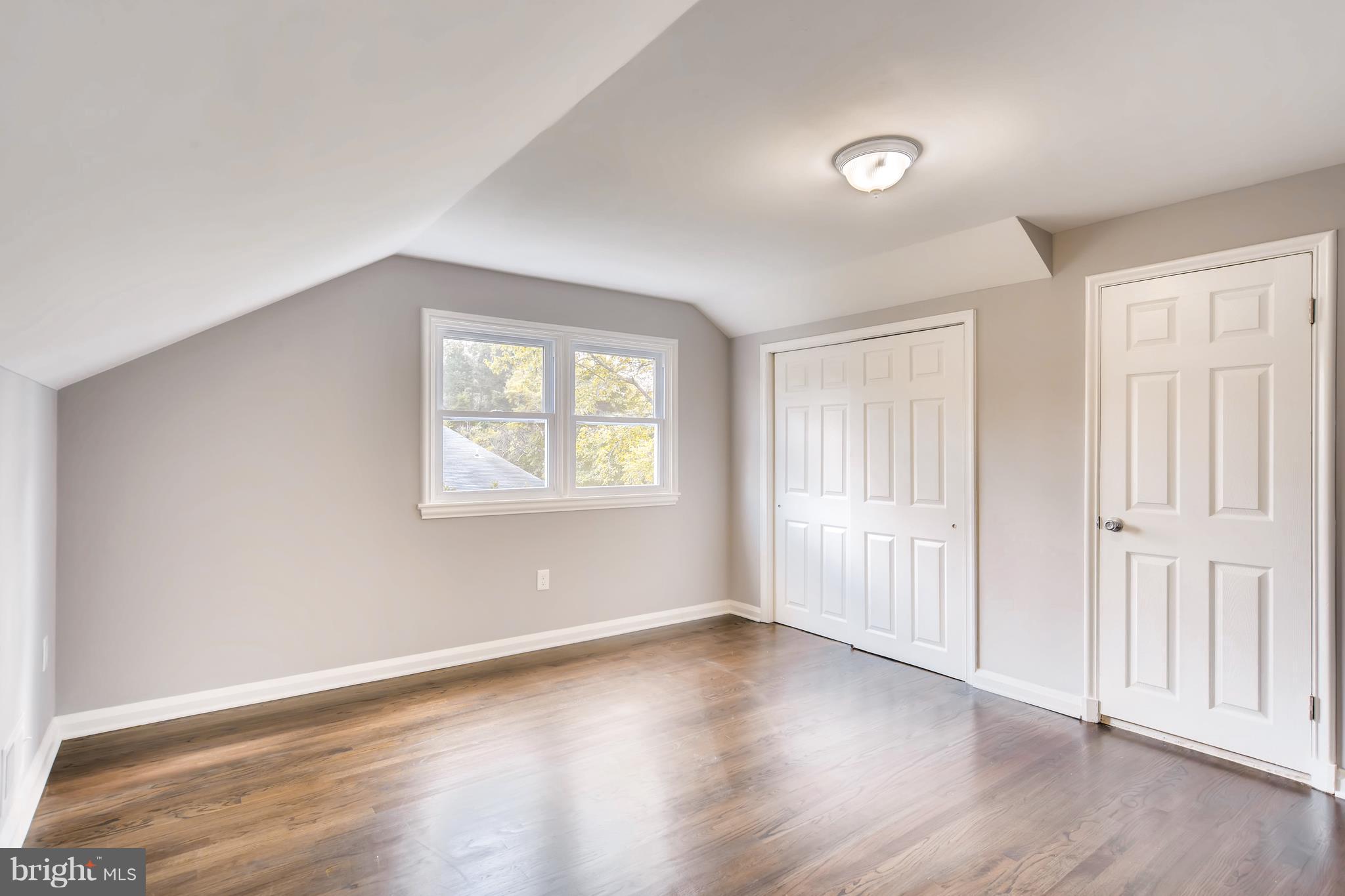 4103 Ronis Road Baltimore, MD 21208 - Photo 15 of 22 an empty room with wooden floor and windows