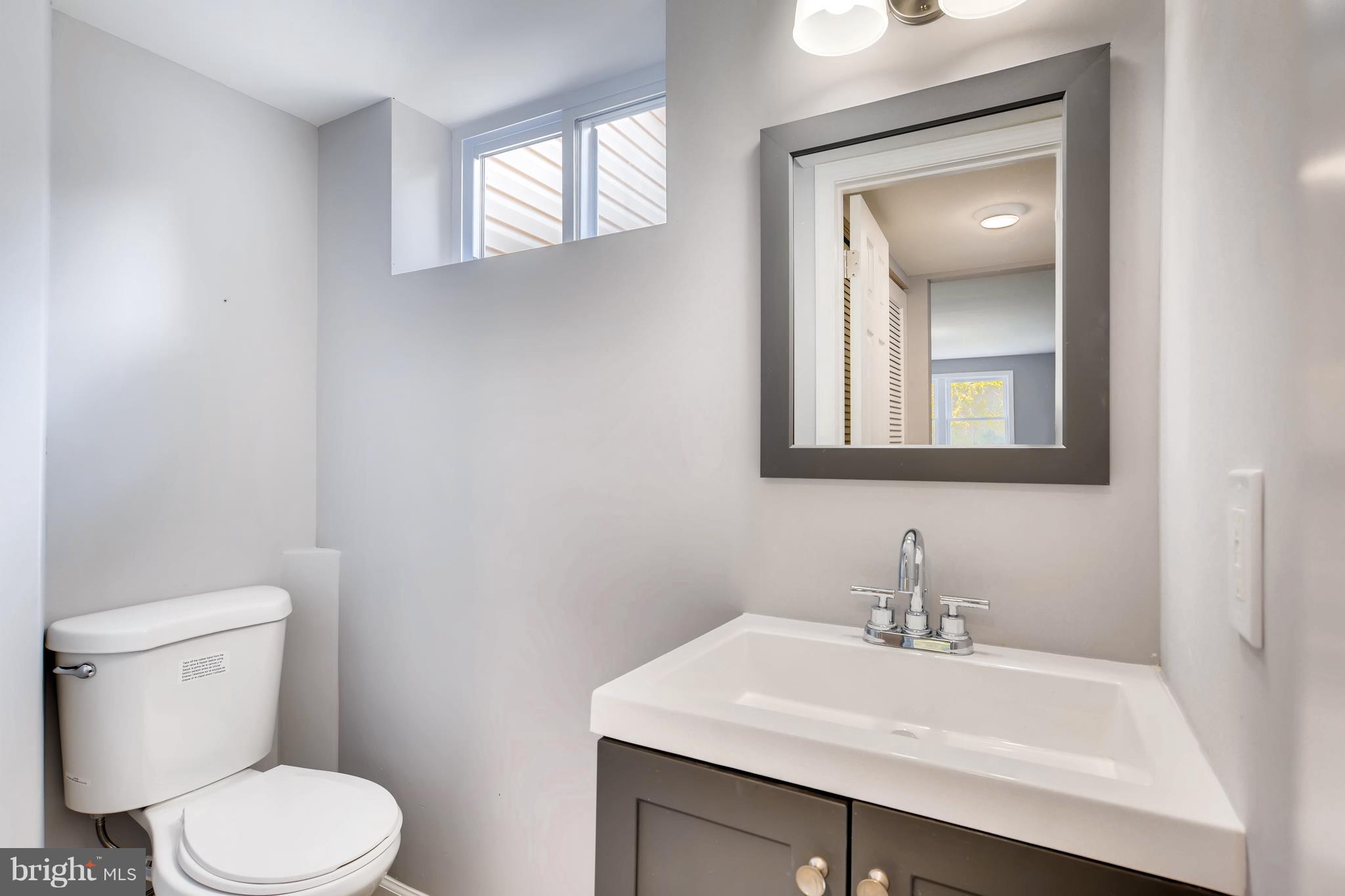 4103 Ronis Road Baltimore, MD 21208 - Photo 20 of 22 a bathroom with a toilet a sink and mirror