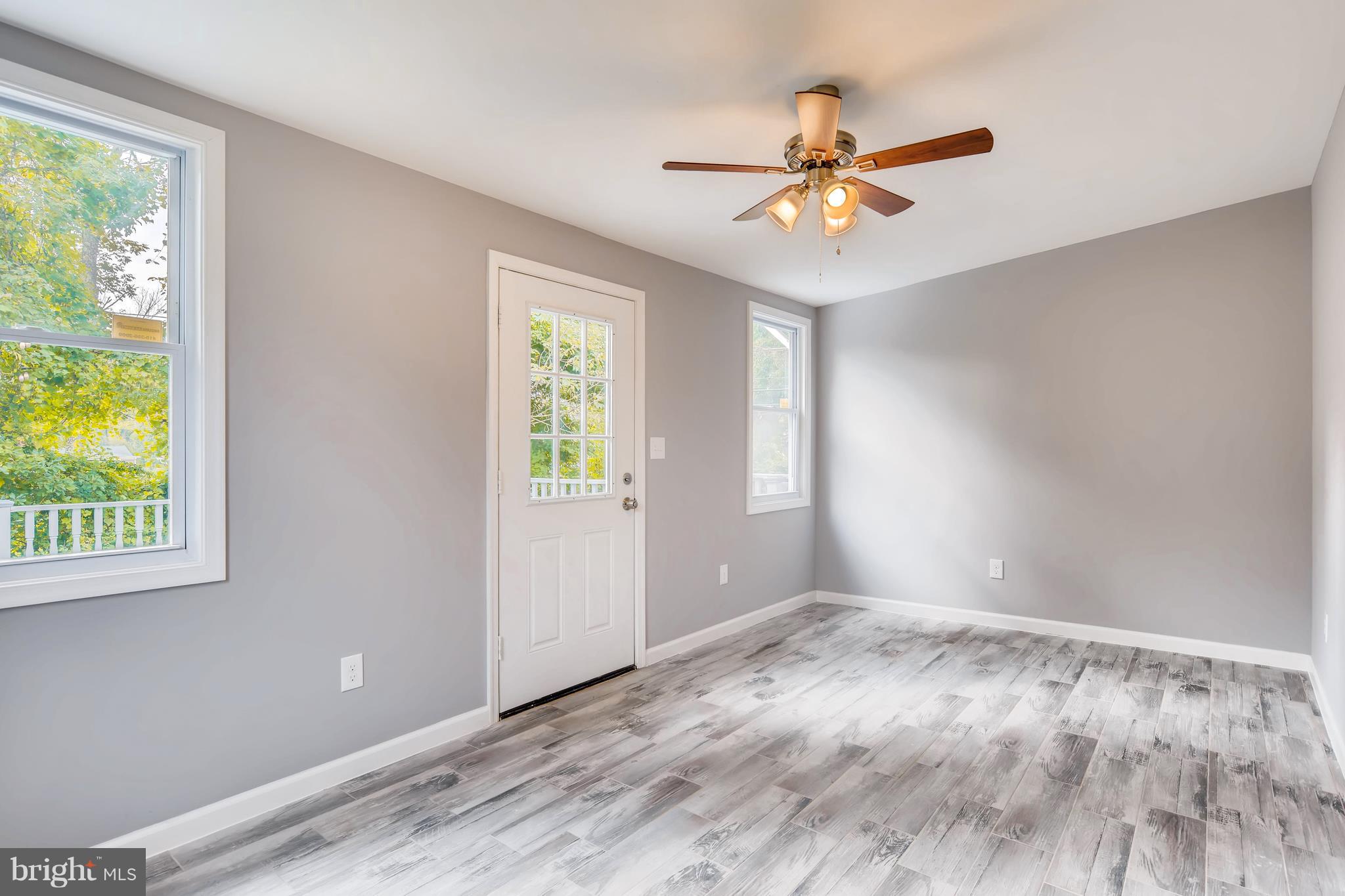 4103 Ronis Road Baltimore, MD 21208 - Photo 21 of 22 a view of a livingroom with a ceiling fan and window