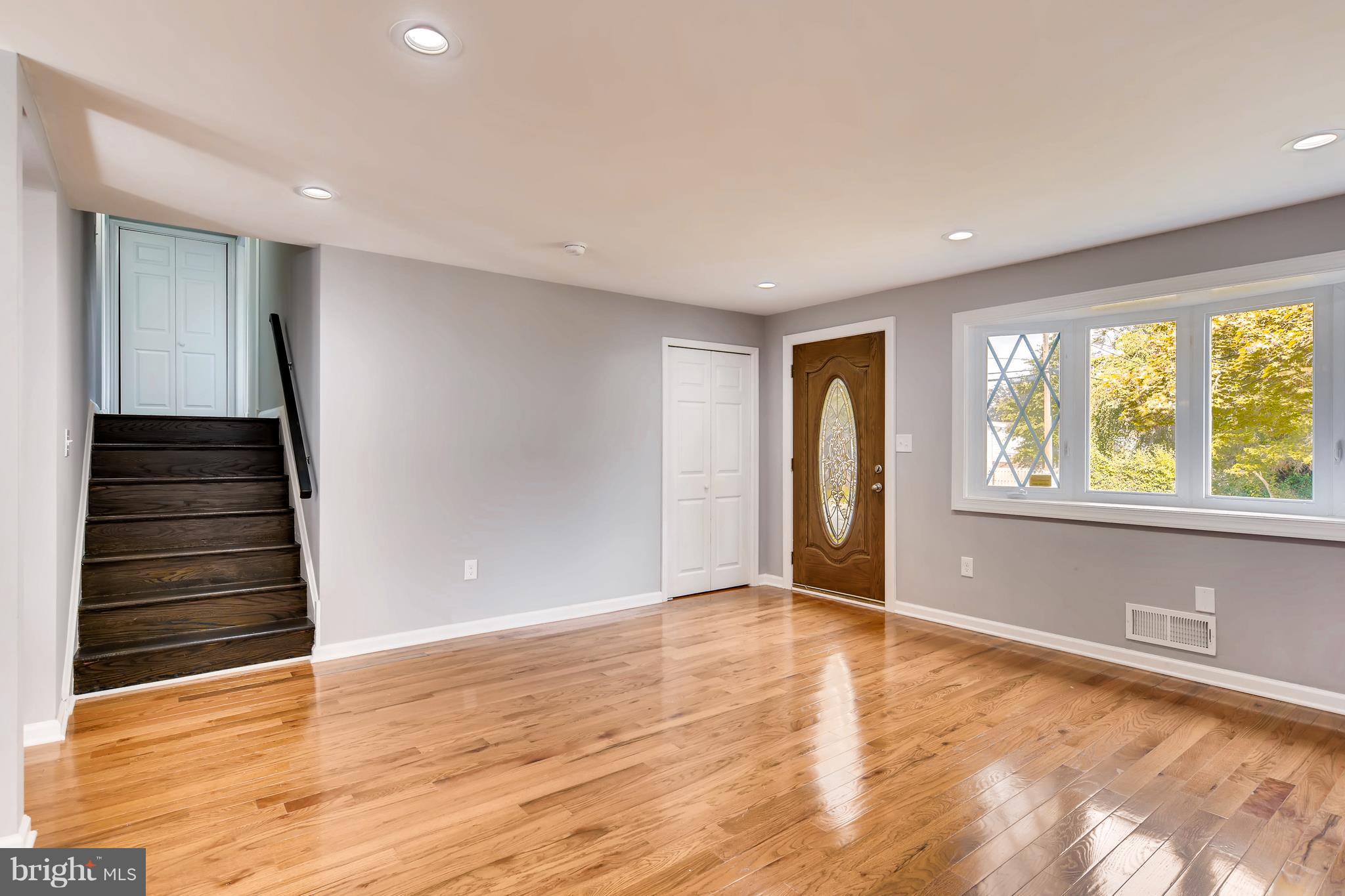 4103 Ronis Road Baltimore, MD 21208 - Photo 5 of 22 a view of an empty room with wooden floor and a window