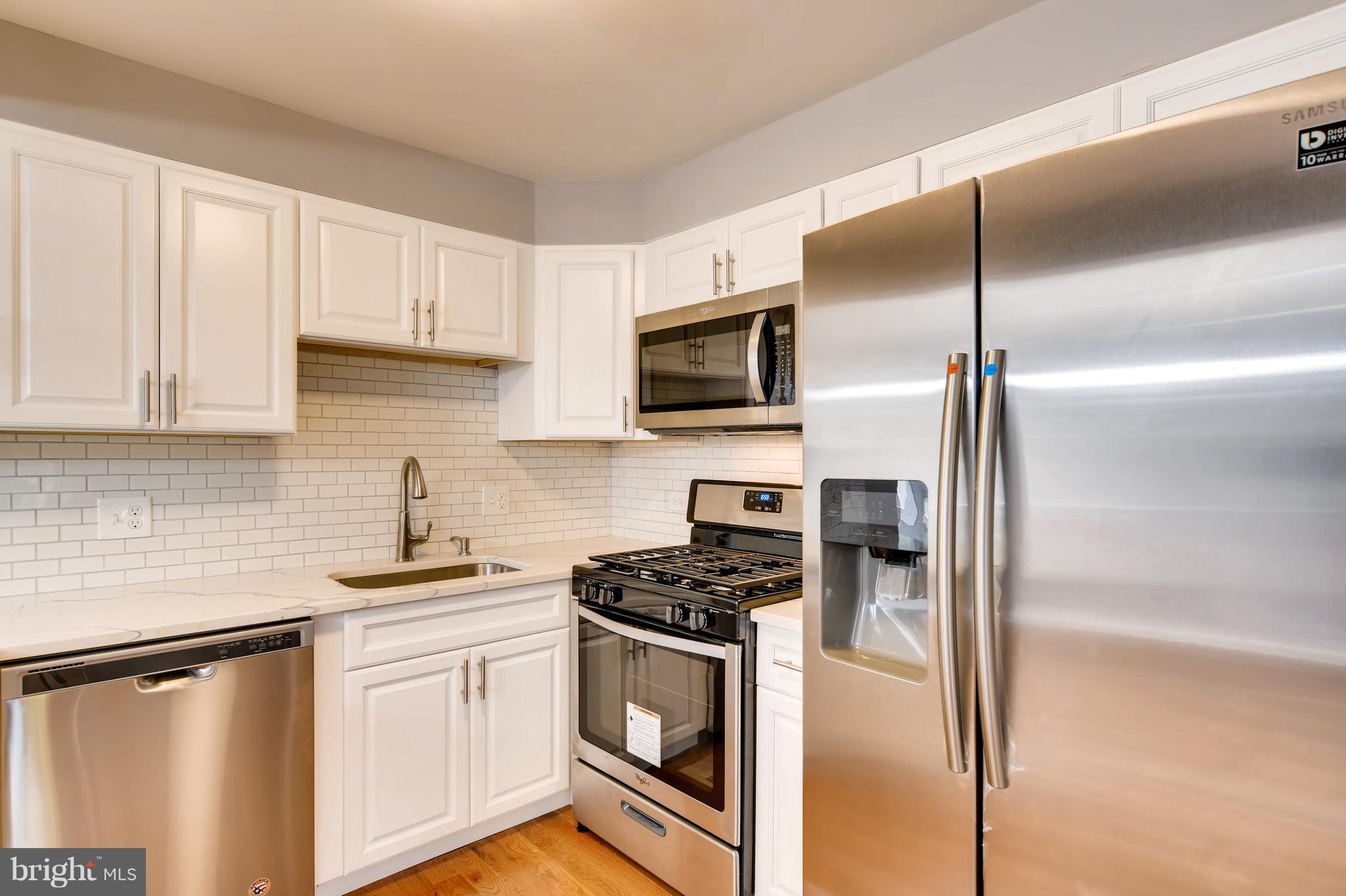 4103 Ronis Road Baltimore, MD 21208 - Photo 10 of 22 a kitchen with cabinets stainless steel appliances and a counter space