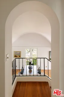 a view of staircase with railing and white walls
