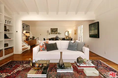 a living room with furniture wooden floor and a flat screen tv