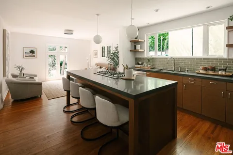 a kitchen with sink cabinets and wooden floor
