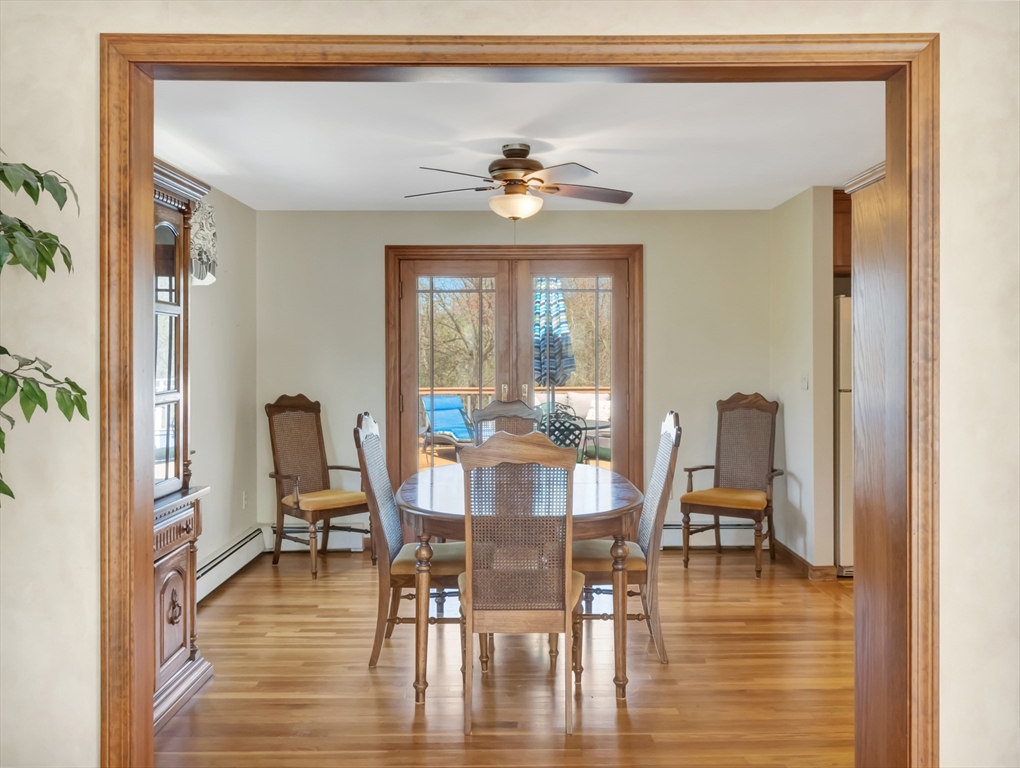 15 Riverside Drive Mansfield, MA 02048 - Photo 9 of 42 a dining room with wooden floor a glass table and chairs