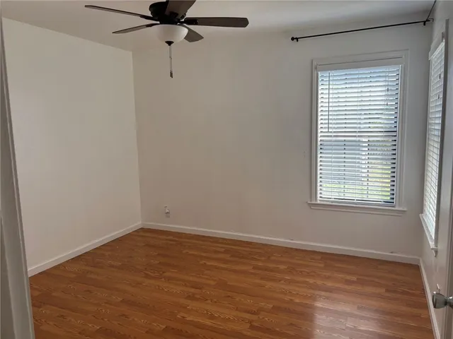 a view of a room with wooden floor and windows