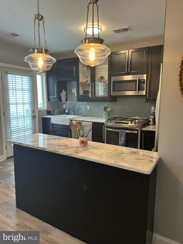 a room with a chandelier furniture and a wooden floor