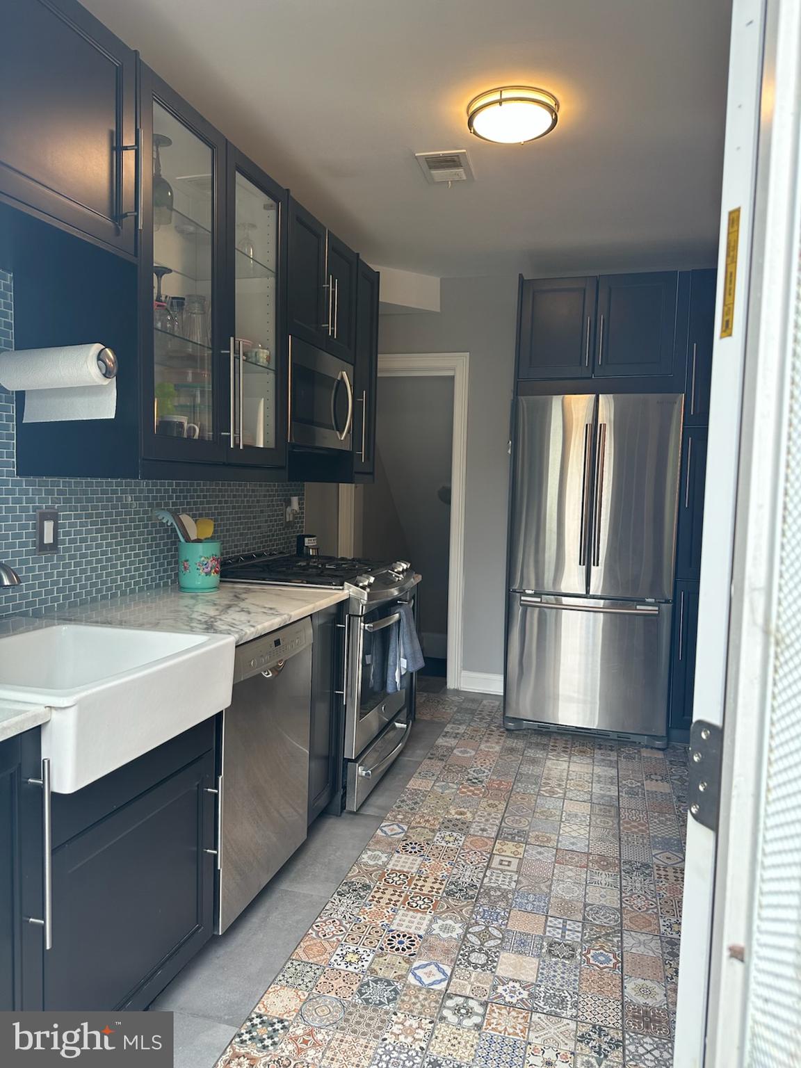4627 12th Street Northeast Washington, DC 20017 - Photo 16 of 56 a kitchen with stainless steel appliances granite countertop a sink stove and refrigerator