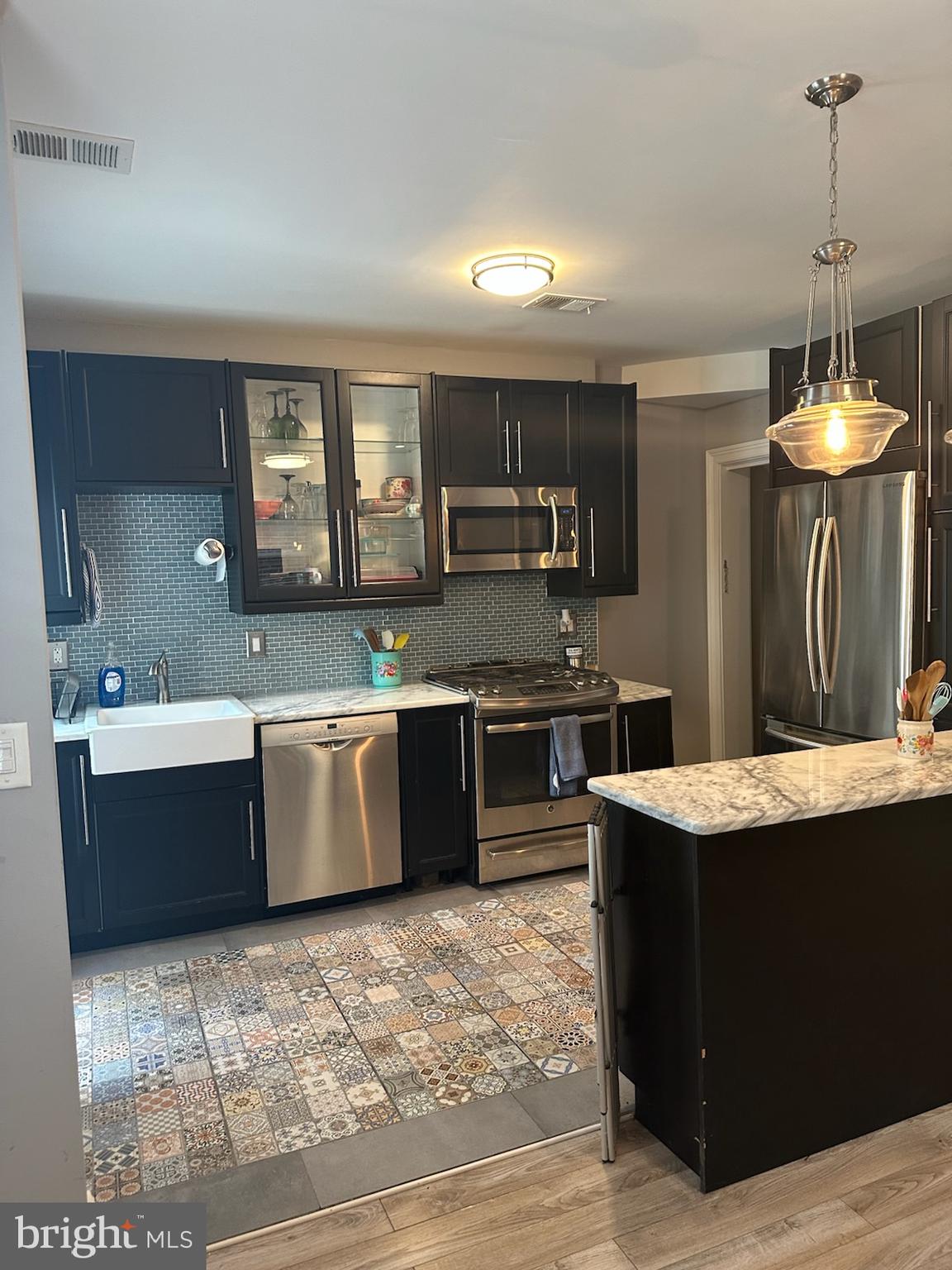 4627 12th Street Northeast Washington, DC 20017 - Photo 17 of 56 a kitchen with stainless steel appliances granite countertop a stove a sink dishwasher and a oven with cabinets