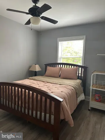 a view of bedroom and hall with wooden floor