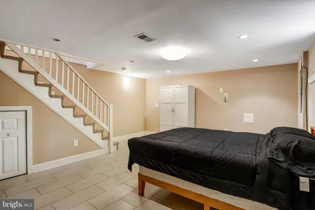 a kitchen with kitchen island a counter top space wooden floor and a refrigerator