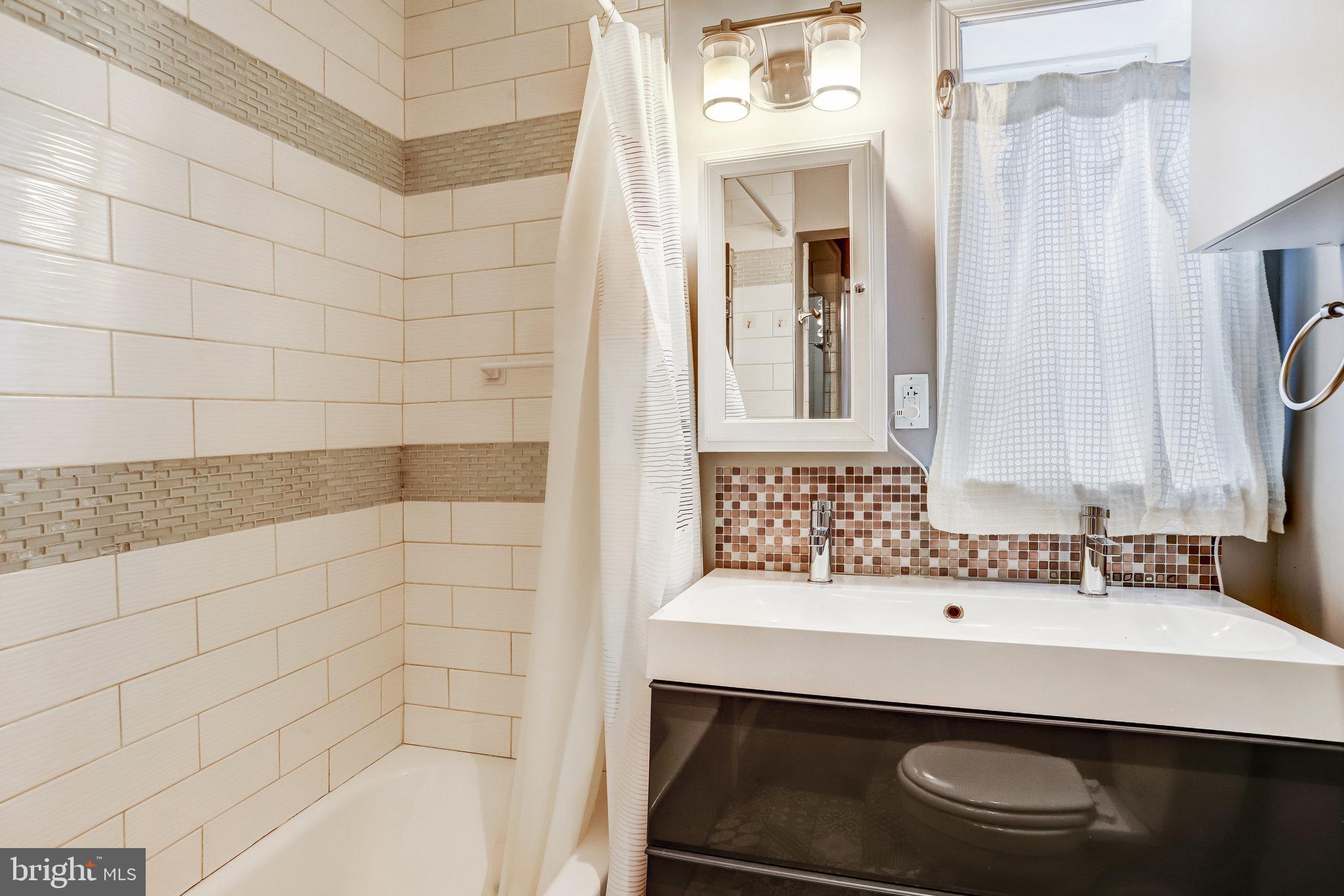 4627 12th Street Northeast Washington, DC 20017 - Photo 30 of 56 a bathroom with a sink and a bathtub