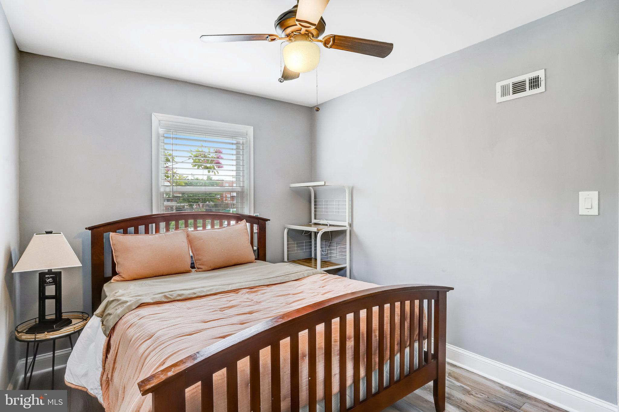 4627 12th Street Northeast Washington, DC 20017 - Photo 31 of 56 a bedroom with a bed and a chandelier