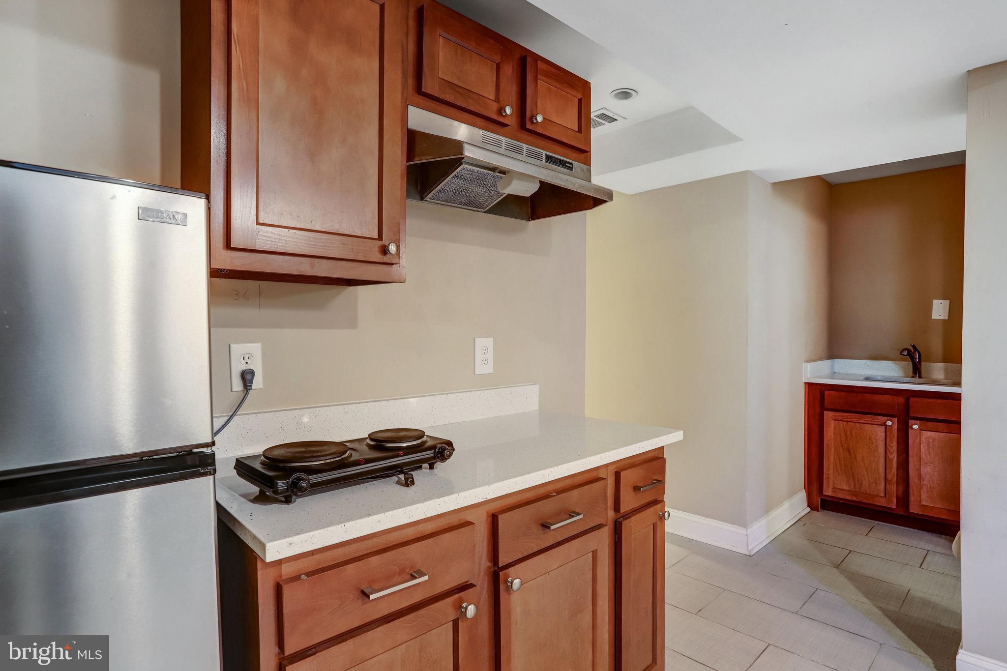 4627 12th Street Northeast Washington, DC 20017 - Photo 34 of 56 a kitchen with stainless steel appliances granite countertop a refrigerator and a sink