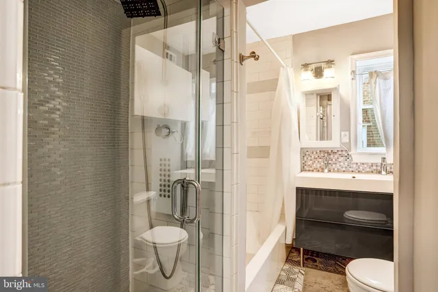 a view of a dining room with furniture a rug and wooden floor