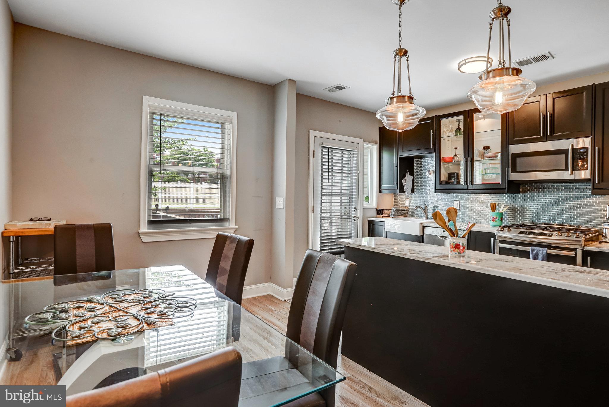 4627 12th Street Northeast Washington, DC 20017 - Photo 45 of 56 a view of a dining room with furniture a rug and wooden floor