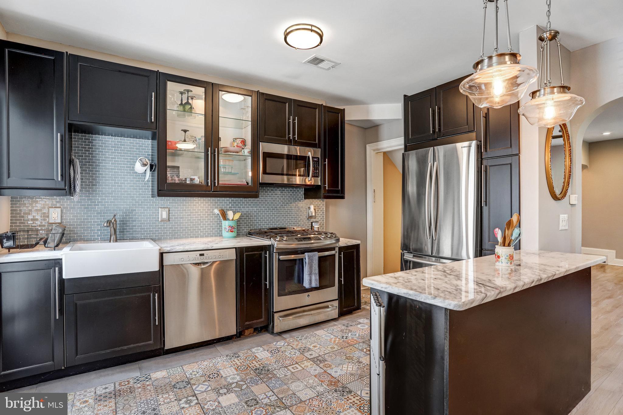 4627 12th Street Northeast Washington, DC 20017 - Photo 47 of 56 a kitchen with stainless steel appliances granite countertop a sink stove and refrigerator