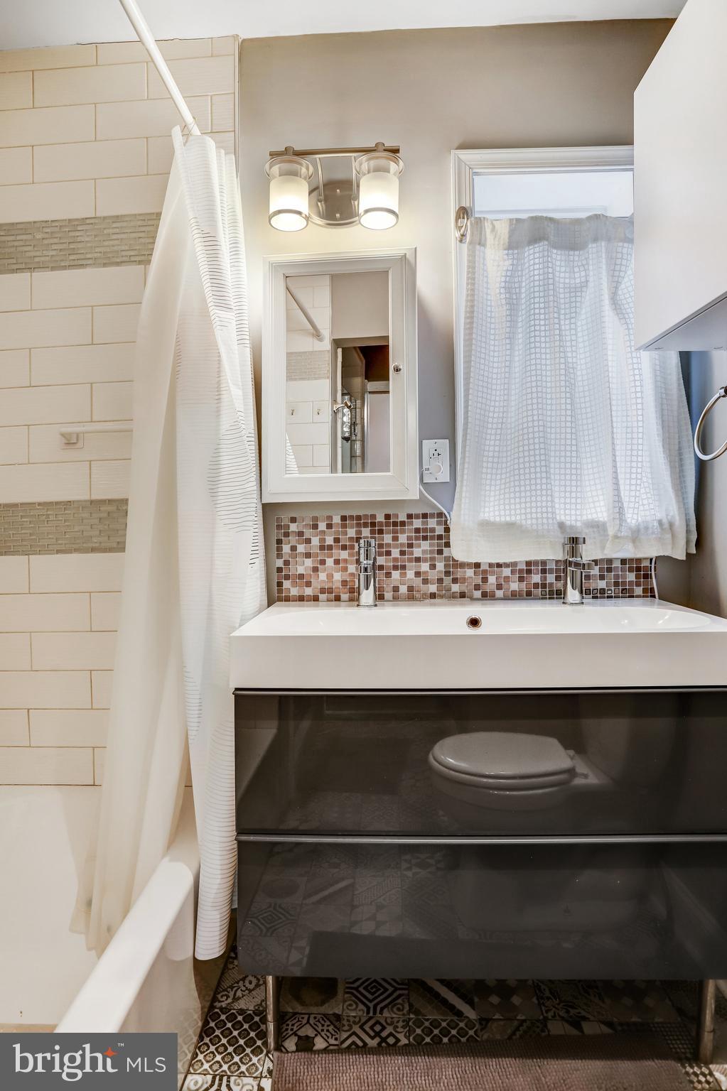 4627 12th Street Northeast Washington, DC 20017 - Photo 50 of 56 a bathroom with a sink and a mirror