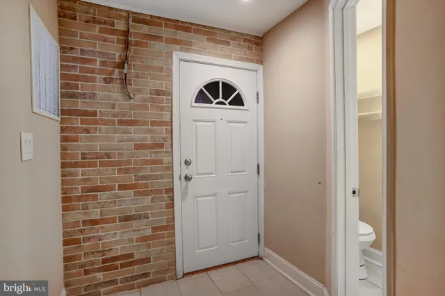 a view of a brick house with a large window