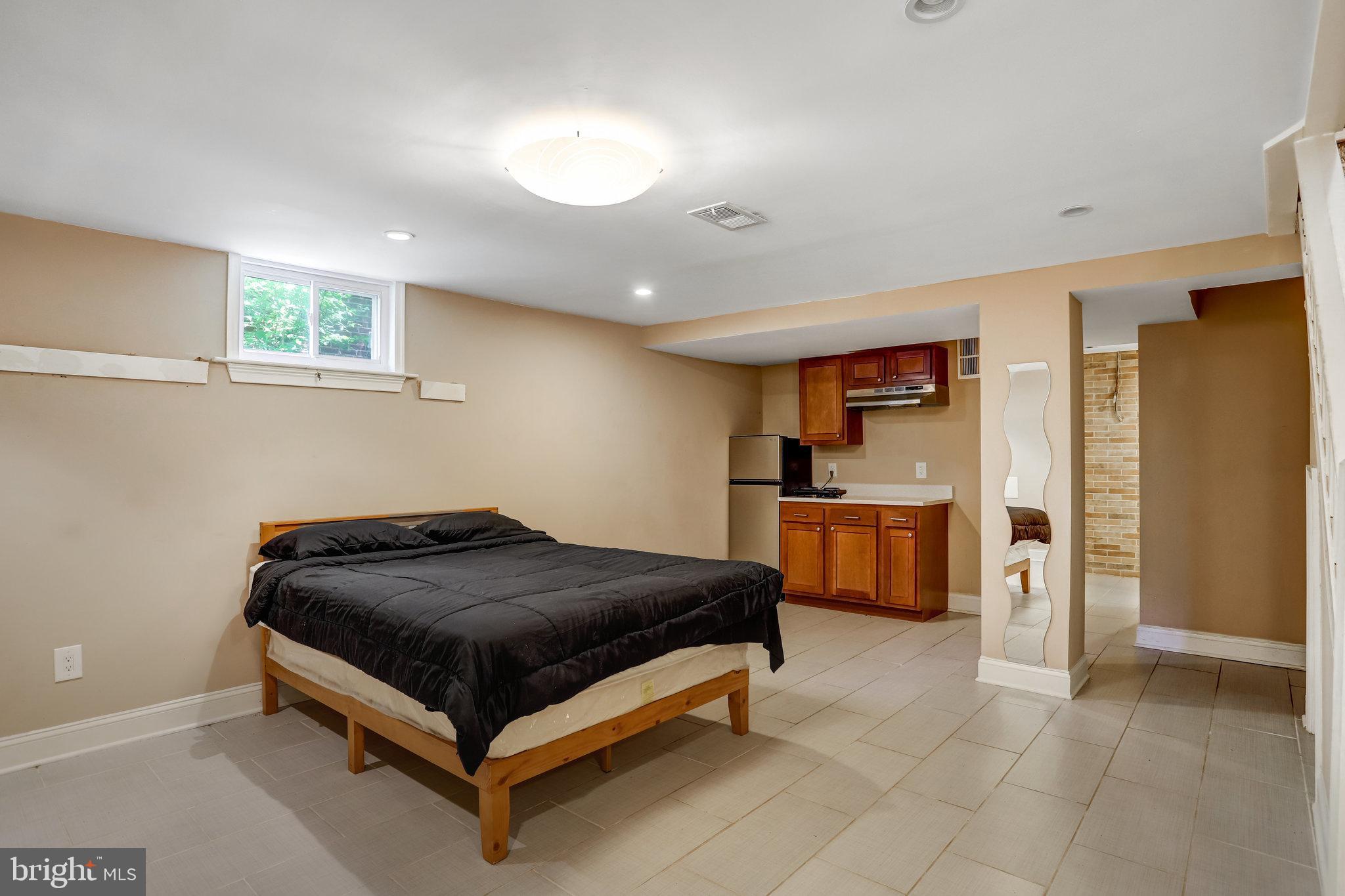4627 12th Street Northeast Washington, DC 20017 - Photo 54 of 56 a bedroom with a bed and a refrigerator
