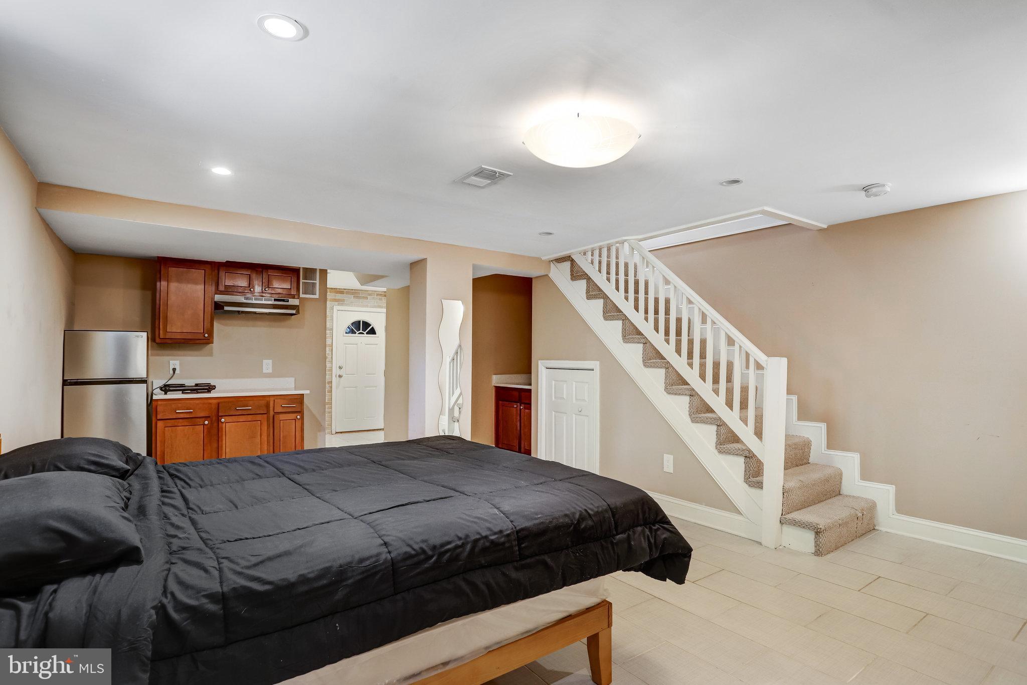 4627 12th Street Northeast Washington, DC 20017 - Photo 56 of 56 a bedroom with a bed and a chandelier