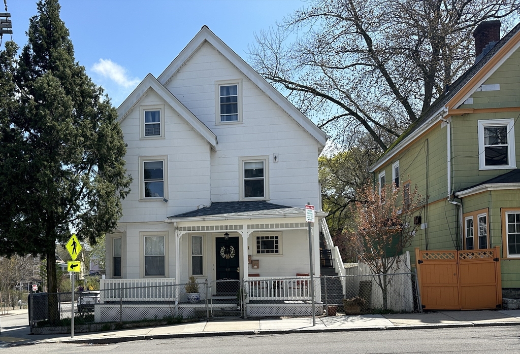 60 Day Street, Unit 1 Boston, MA 02130 - Photo 10 of 10 a view of a white house with large windows and a tree