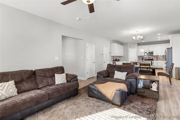 a kitchen with granite countertop a sink a counter space appliances and cabinets