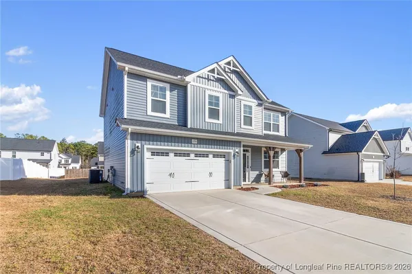a living room with a fireplace and flat screen tv