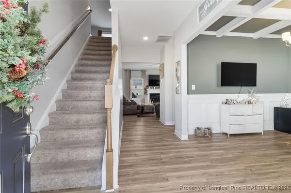 a living room with furniture kitchen view and a couch