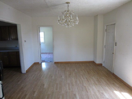 315 8th Street Rochelle, IL 61068 - Photo 4 of 11 a view of a hallway with wooden floor and staircase
