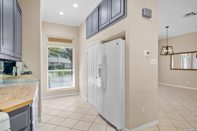 a view of kitchen with furniture and refrigerator