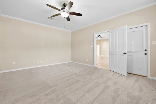 an empty room with fan and a ceiling fan