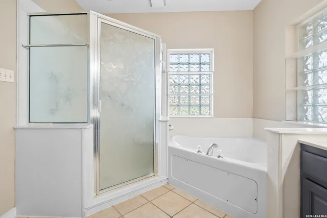 a bathroom with a bathtub and a shower