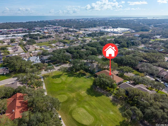 an aerial view of residential house with yard and swimming pool